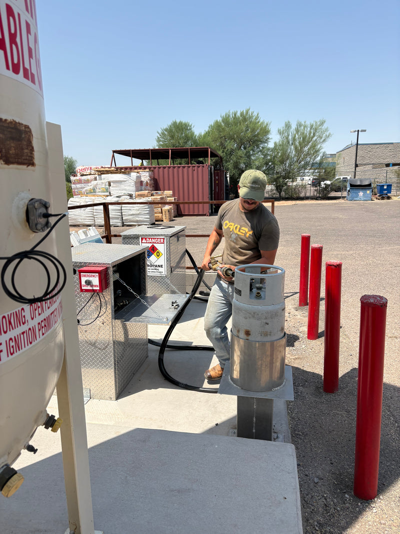 The Stock Shop team member refilling a portable propane tank at our Apache Junction, AZ location
